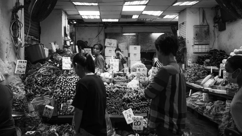 Shopper carefully inspecting a returned electronic device at a bin store for damage or missing parts