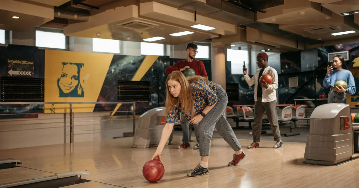 Beginner bowler learning how to bowl at a local bowling alley