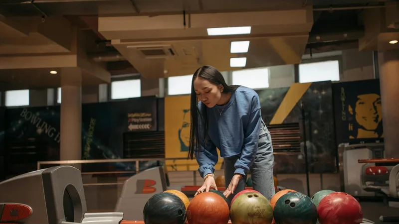 Bowling lane with pins set up and arrow markers visible on the approach area