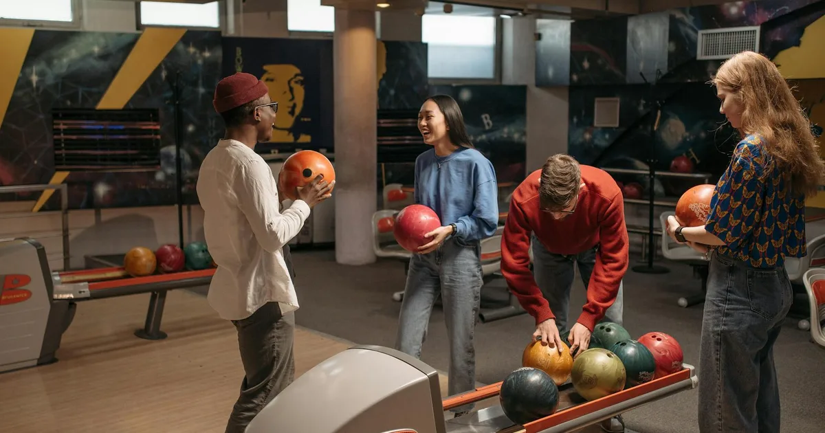 Friends having fun at a Bowling Pal venue, bowling together