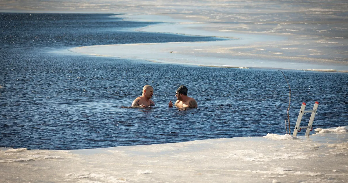 Person preparing for a cold plunge session in an ice bath facility