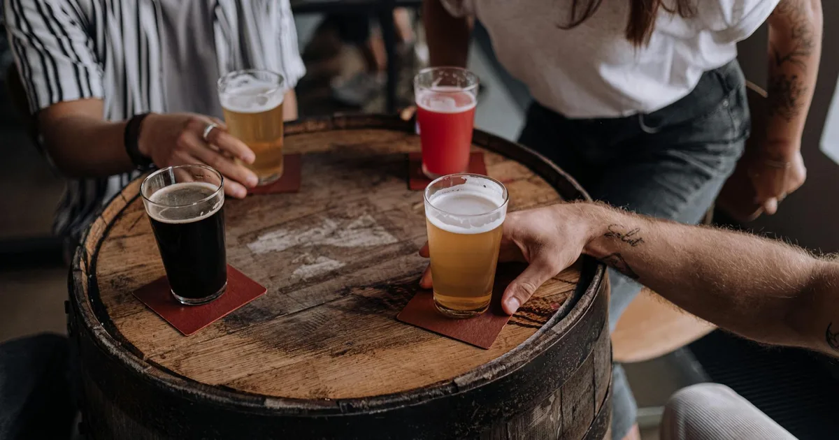 Group of friends enjoying a lively atmosphere at a Craft Brewery Pal.
