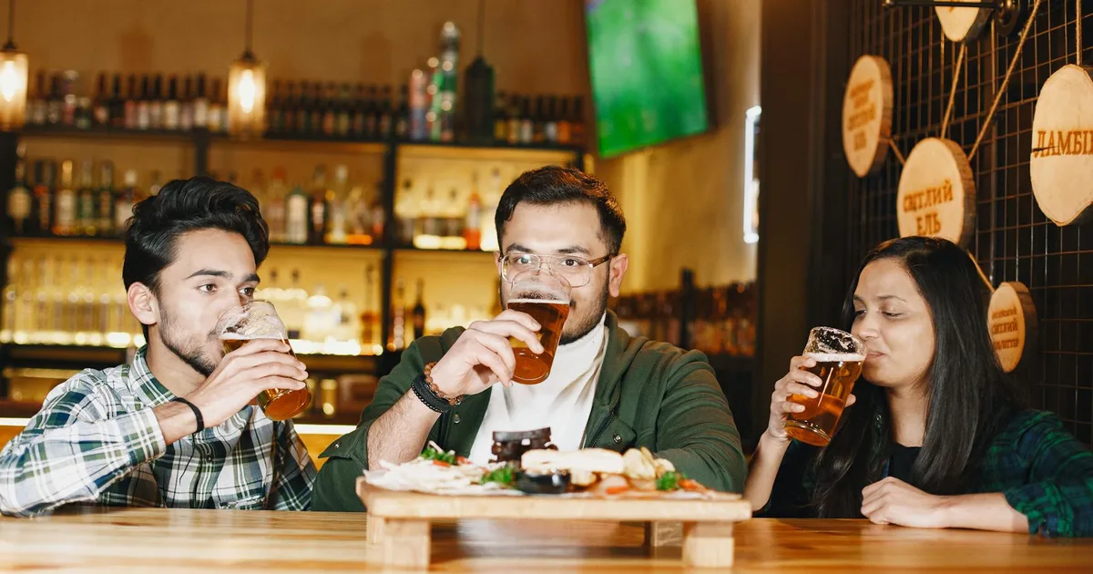 Group of friends enjoying craft beer at a taproom with Craft Brewery Pal.