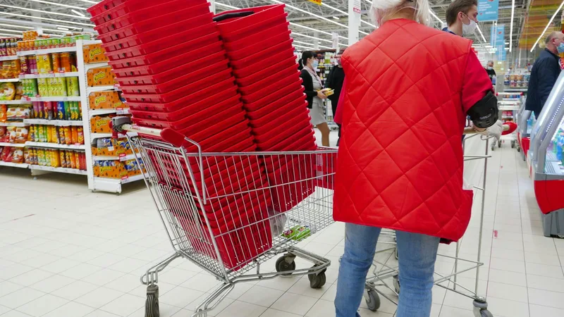 Shopper browsing shelves at a discount variety store with cleaning products and household goods