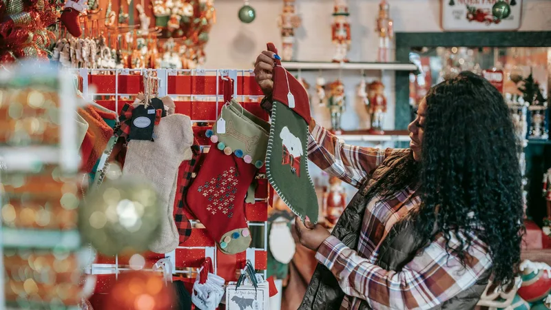 Colorful holiday decorations and seasonal merchandise lining the aisles of a dollar store