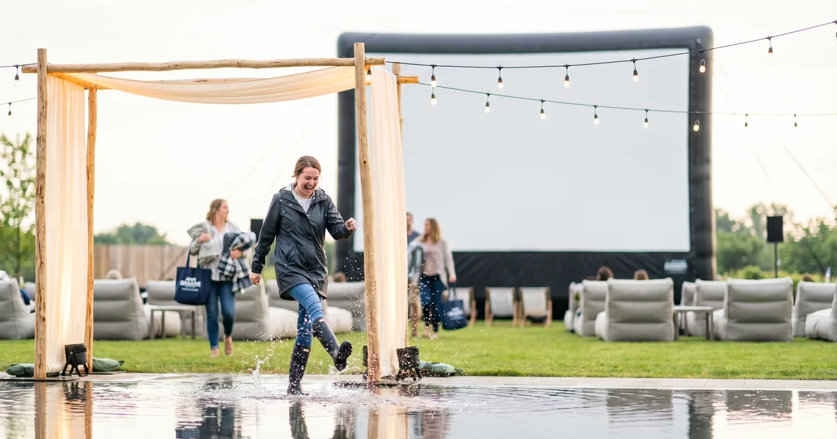Audience enjoying a film at an outdoor cinema with Drive-In Pal.