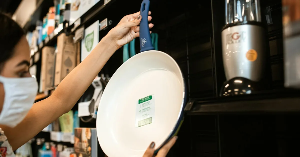 Customers at a Liquidation Store Pal examining discounted kitchen appliances.