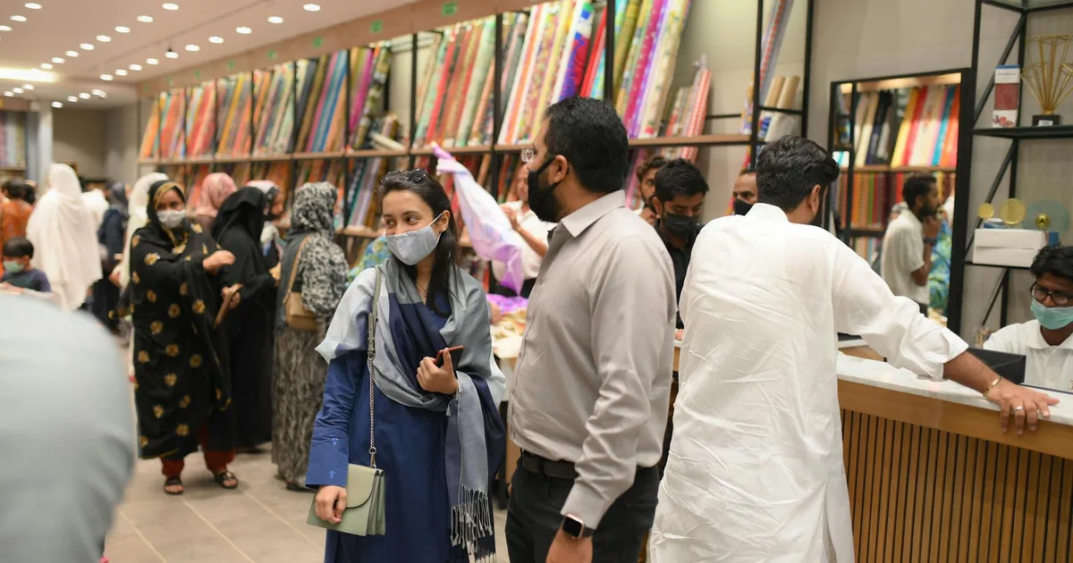 Customers engaging with products at a Liquidation Store Pal location.