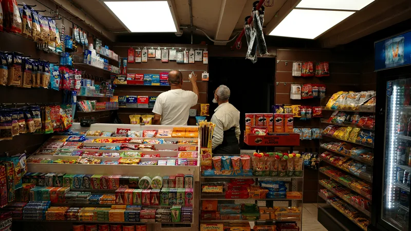 Rows of mixed merchandise at a surplus store including electronics, furniture, and household goods at discounted prices