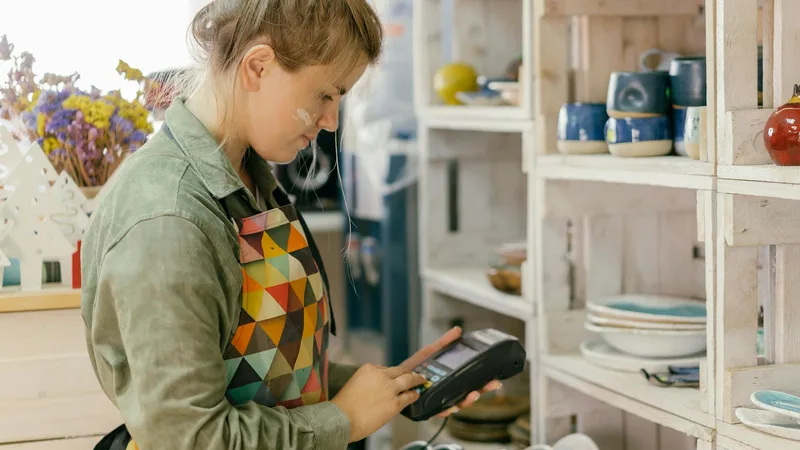 Shopper browsing shelves at a closeout store looking at discounted merchandise