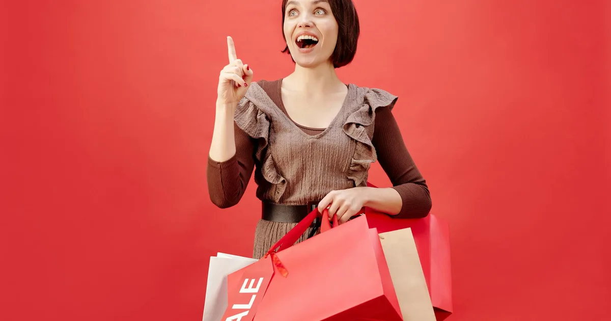 Shopper browsing shelves at a liquidation store filled with discounted merchandise