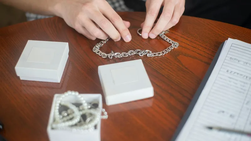Customer at a pawn store counter receiving a cash loan on jewelry from a pawnbroker