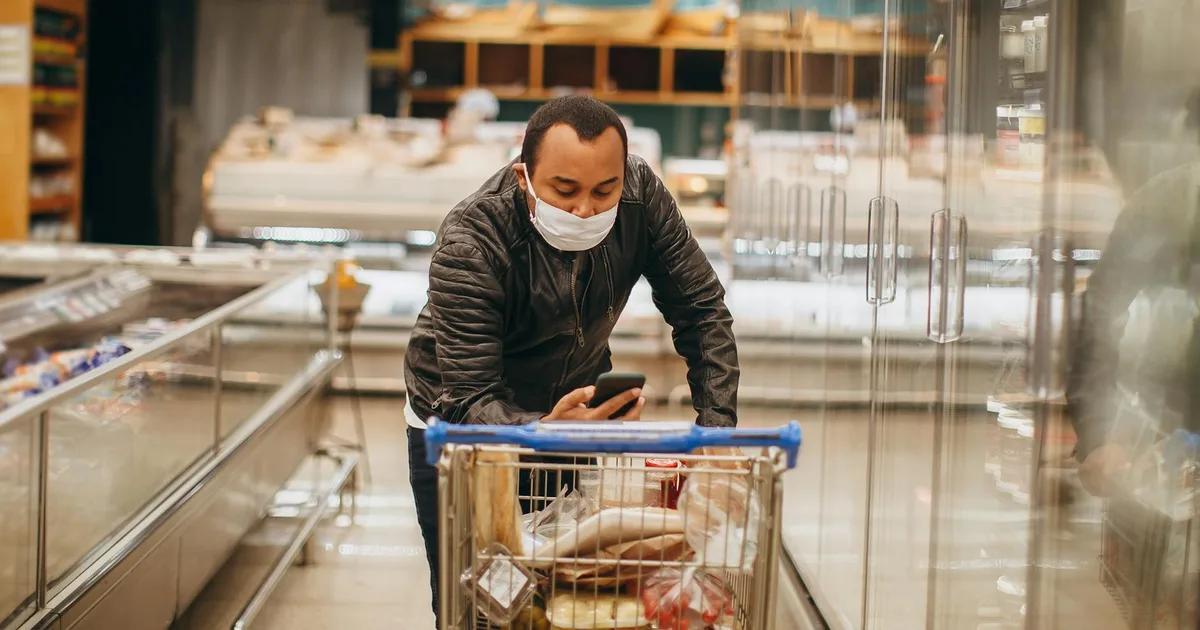 Customer pushing a cart in an aisle at a Salvage Grocery Store