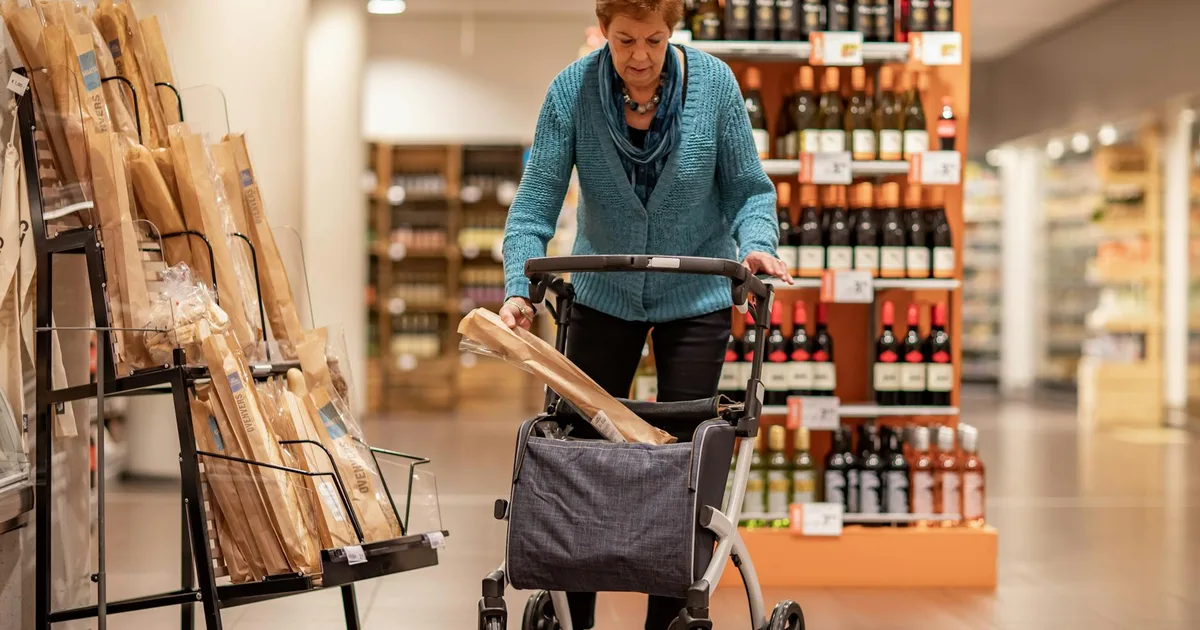 Customer shopping in an American supermarket, exploring options at Salvage Grocery Stores.