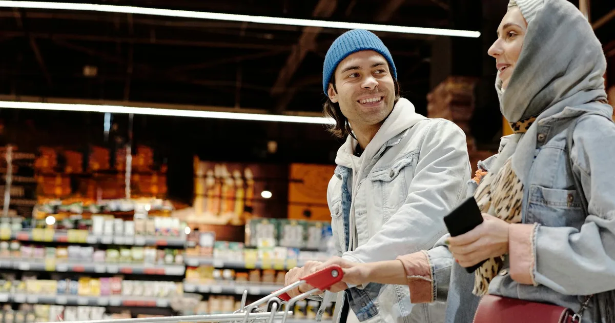 Customer shopping at Salvage Grocery Stores selecting items from shelves