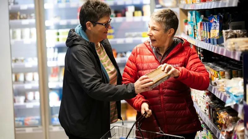 Customers engaging with products at Salvage Grocery Stores during shopping
