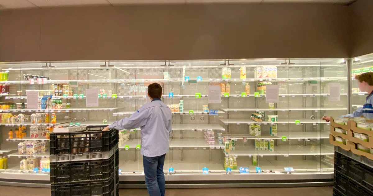 Inside a salvage grocery store showing shelves of discounted and dented food products