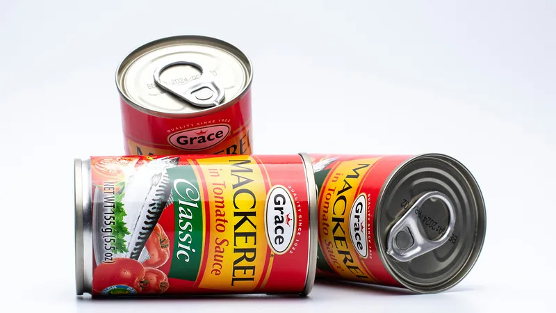 Shopper comparing prices at a discount grocery store with canned goods and pantry items on shelves