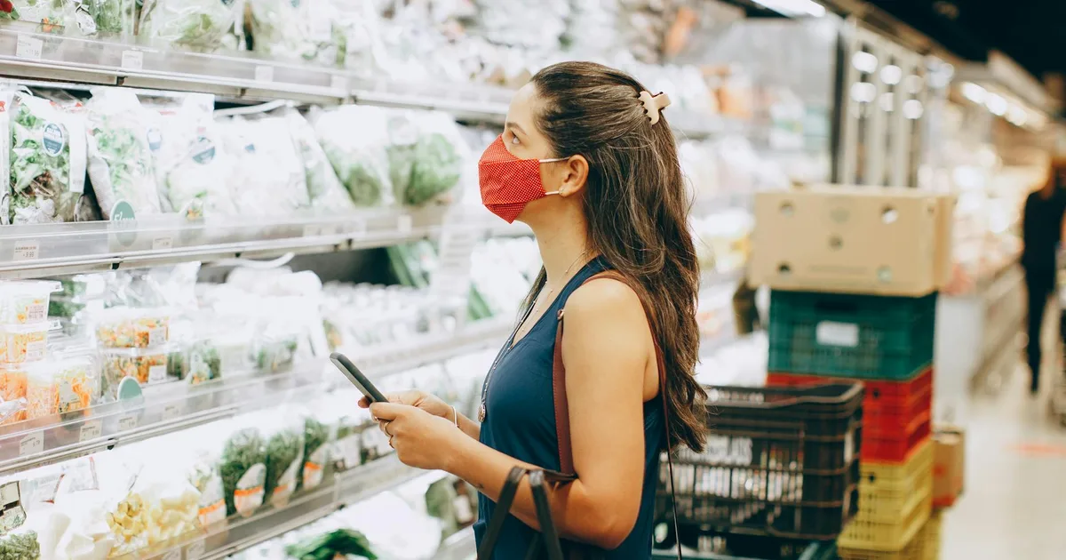 Customer browsing shelves in Salvage Grocery Stores for great deals.