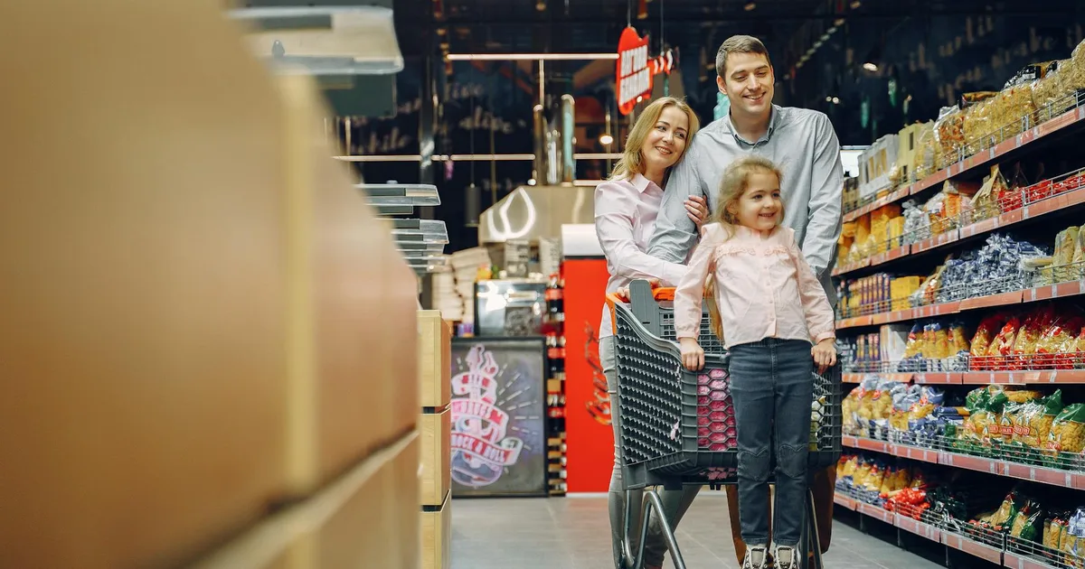 Customer browsing shelves in American supermarket at Salvage Grocery Stores