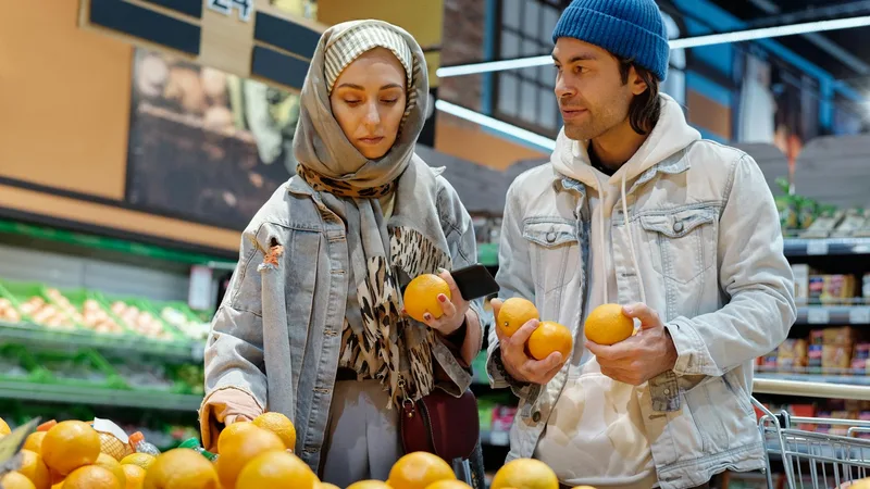 Shelves stocked with discounted canned goods and labeled salvage grocery items at a bent-n-dent discount store