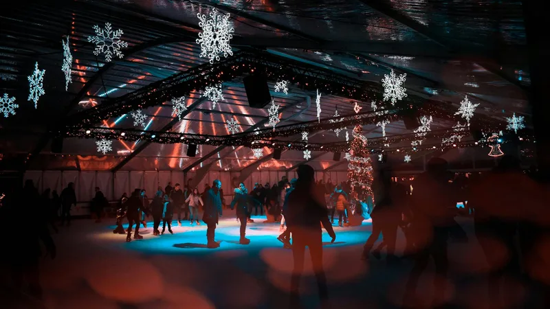 Beginner skaters holding onto the rink wall while learning to skate