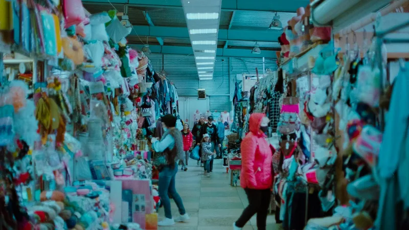 Rows of mixed inventory at a surplus store clearance event including tools, electronics, and clothing
