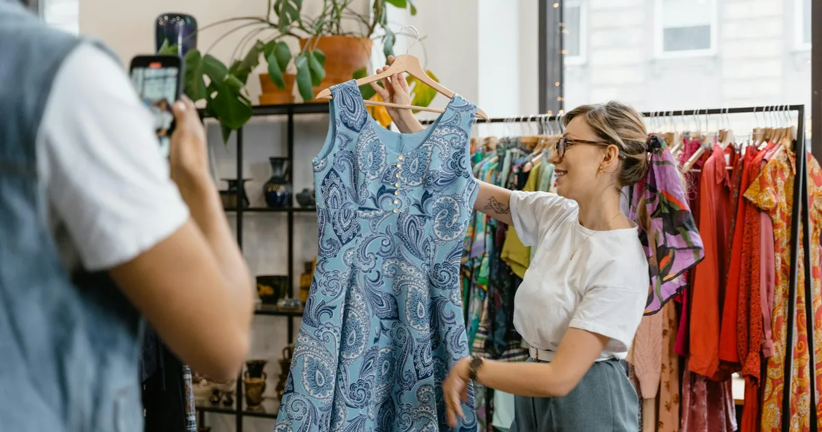 Happy shoppers interacting at a Thrift Store Pal, exploring colorful items.