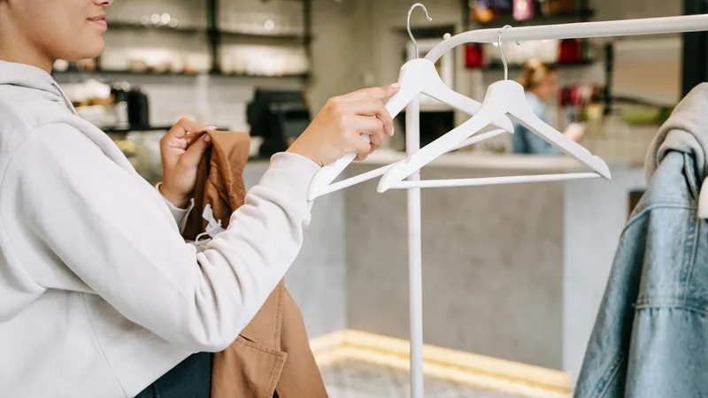 Customers exploring clothing options while using Thrift Store Pal resources